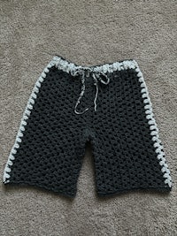 a black and white crocheted shorts on a carpet